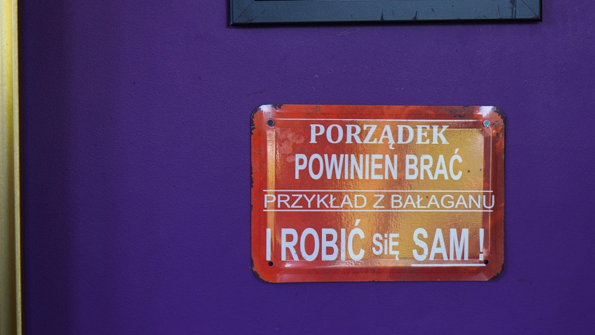 A purple door with two signs on it